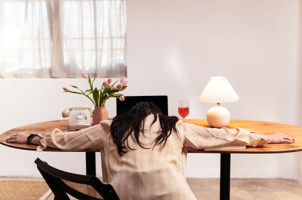 Femme affalée sur le bureau séquelles du burn out
